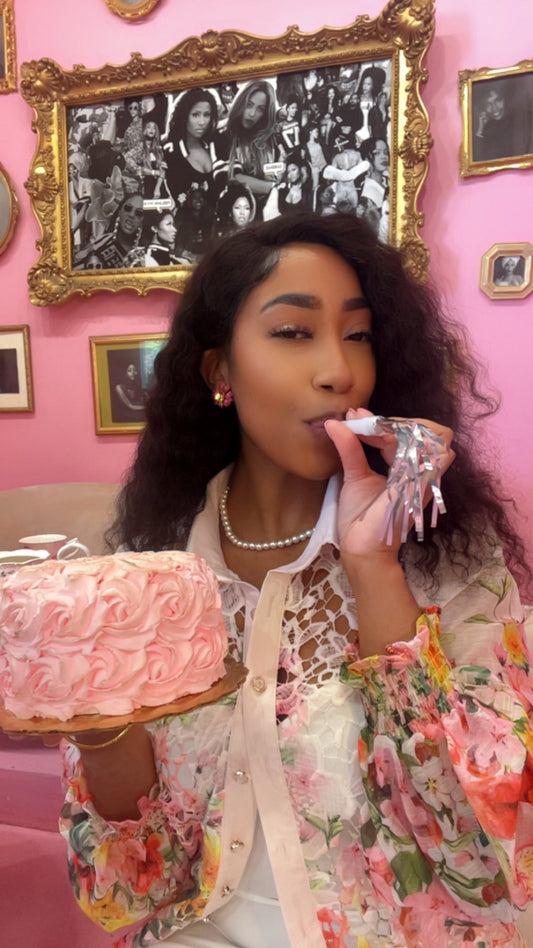 Owner of The Pink Room, Symone Grady Celebrating with a pink cake