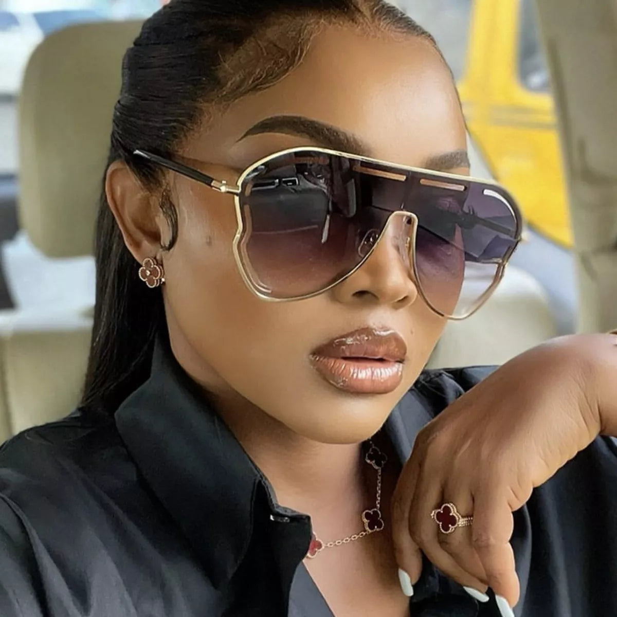Woman wearing the "The Vibe" Oversized Aviator Gradient Sunglasses from The Pink Room.