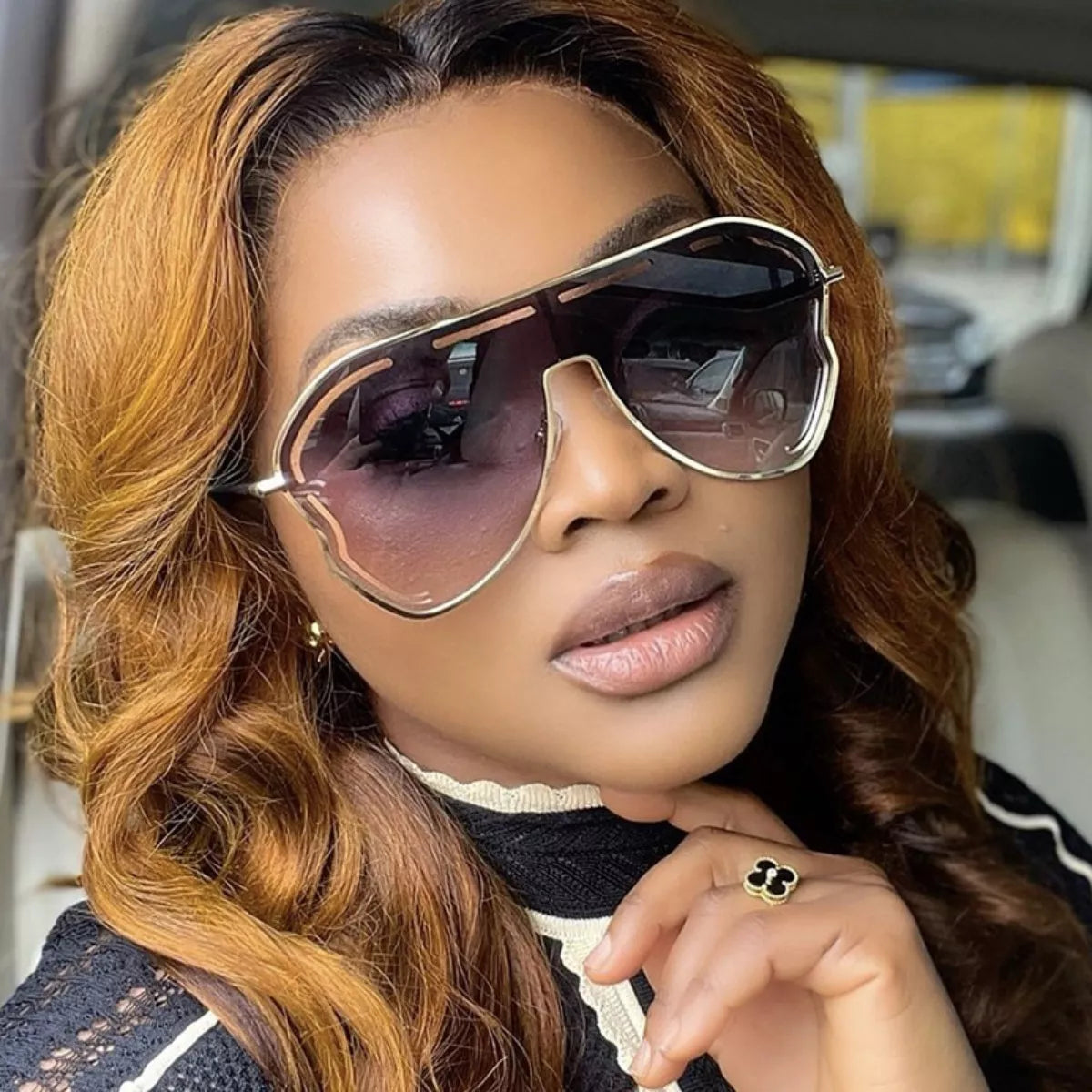 Woman wearing the "The Vibe" Oversized Aviator Gradient Sunglasses from The Pink Room.